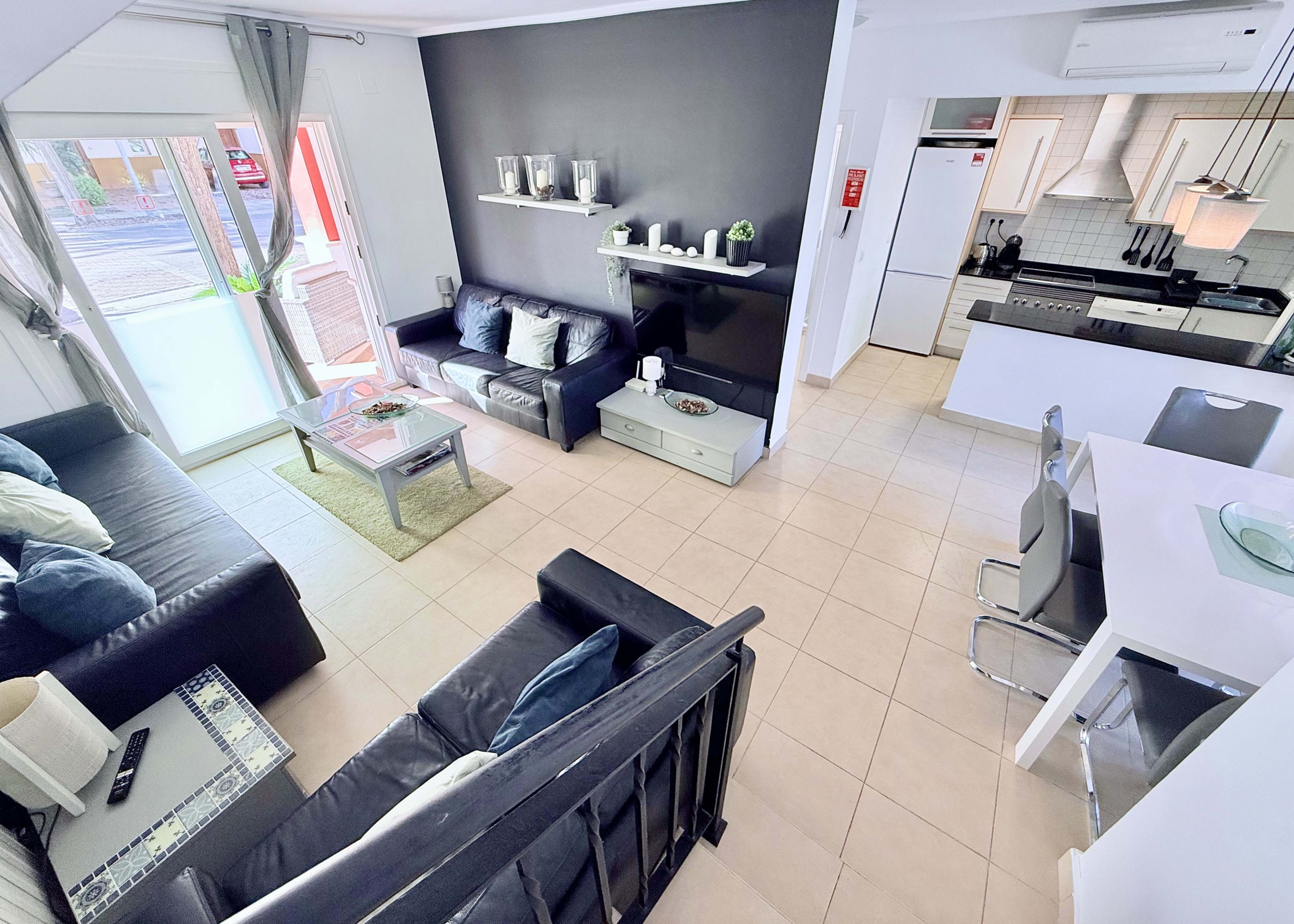 Open-plan living and dining area with terrace access at the Isla Grosa villa on Mar Menor Golf Resort.