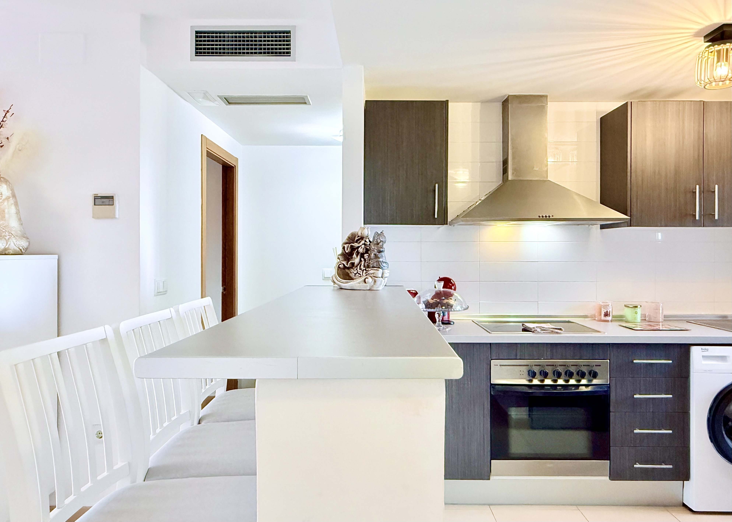 2-Bed Elegant Apartment modern kitchen with breakfast bar in a Levante Properties apartment at Mar Menor Golf Resort.