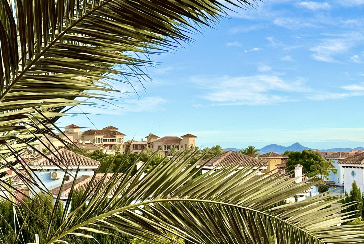 2-Bed Elegant Apartment with resort view showing rooftops and the hotel in the distance at Mar Menor Golf Resort, listed by Levante Properties.