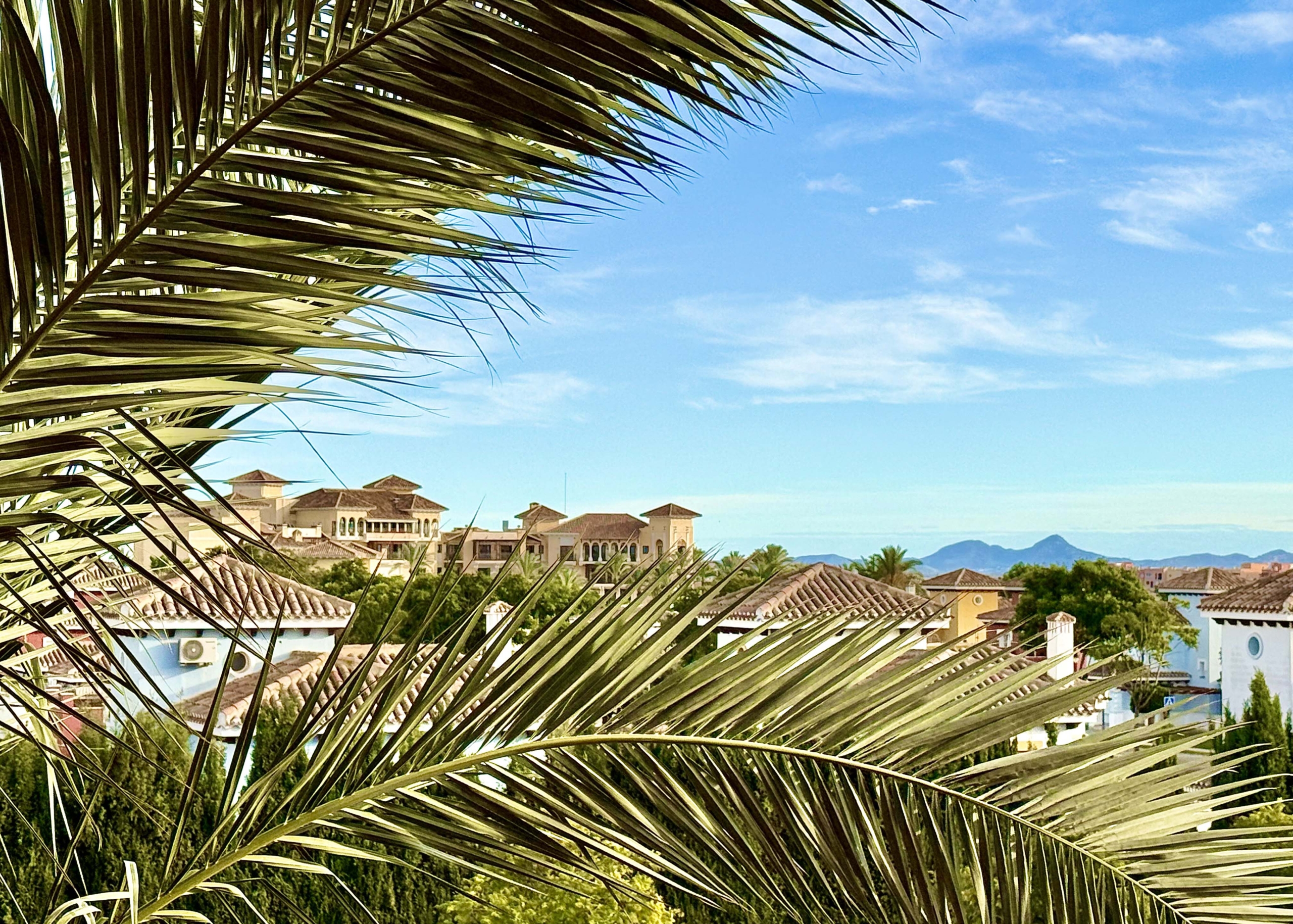 2-Bed Elegant Apartment with resort view showing rooftops and the hotel in the distance at Mar Menor Golf Resort, listed by Levante Properties.