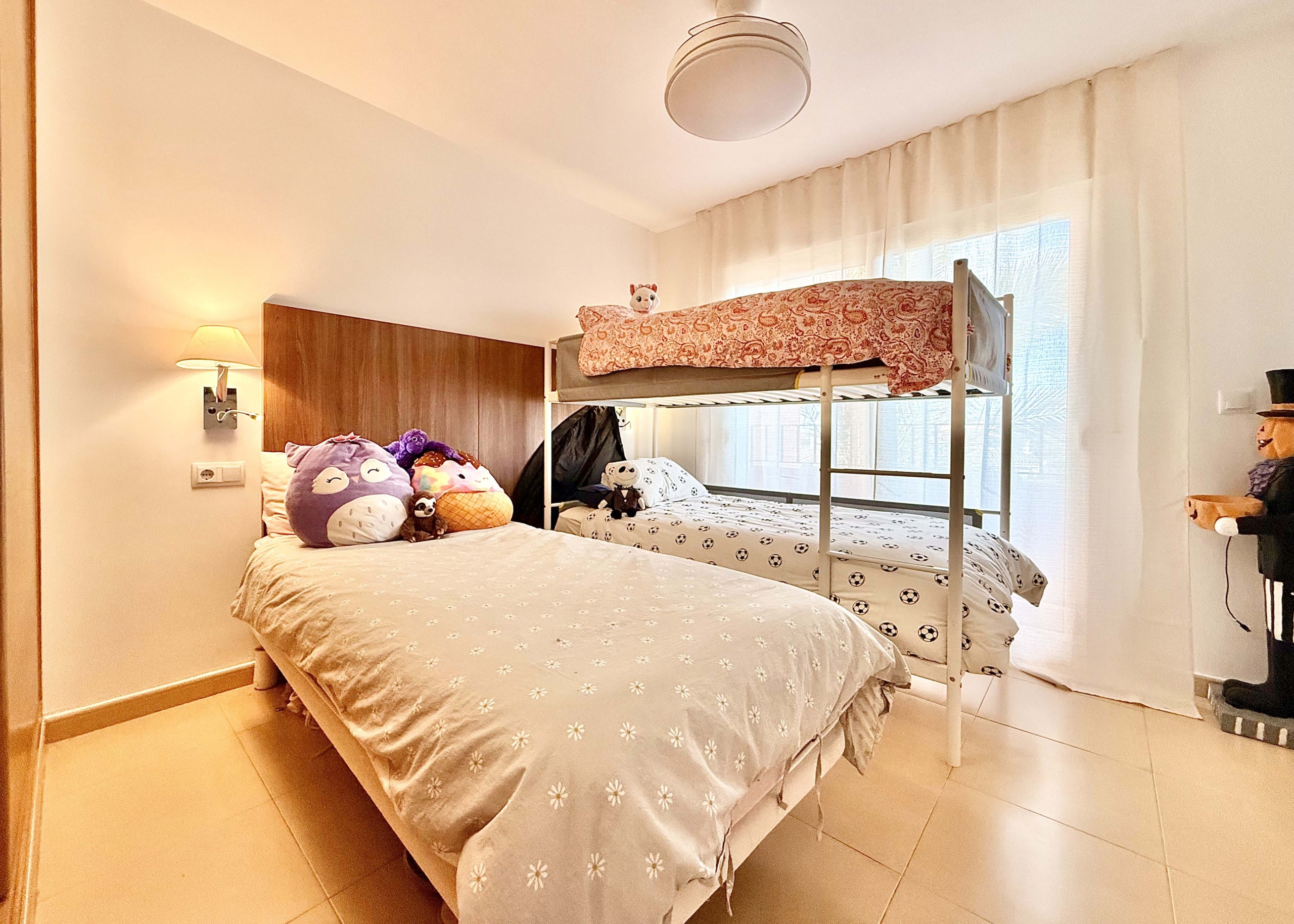 2-Bed Elegant Apartment second bedroom with private terrace and resort views at Mar Menor Golf Resort, Levante Properties listing.