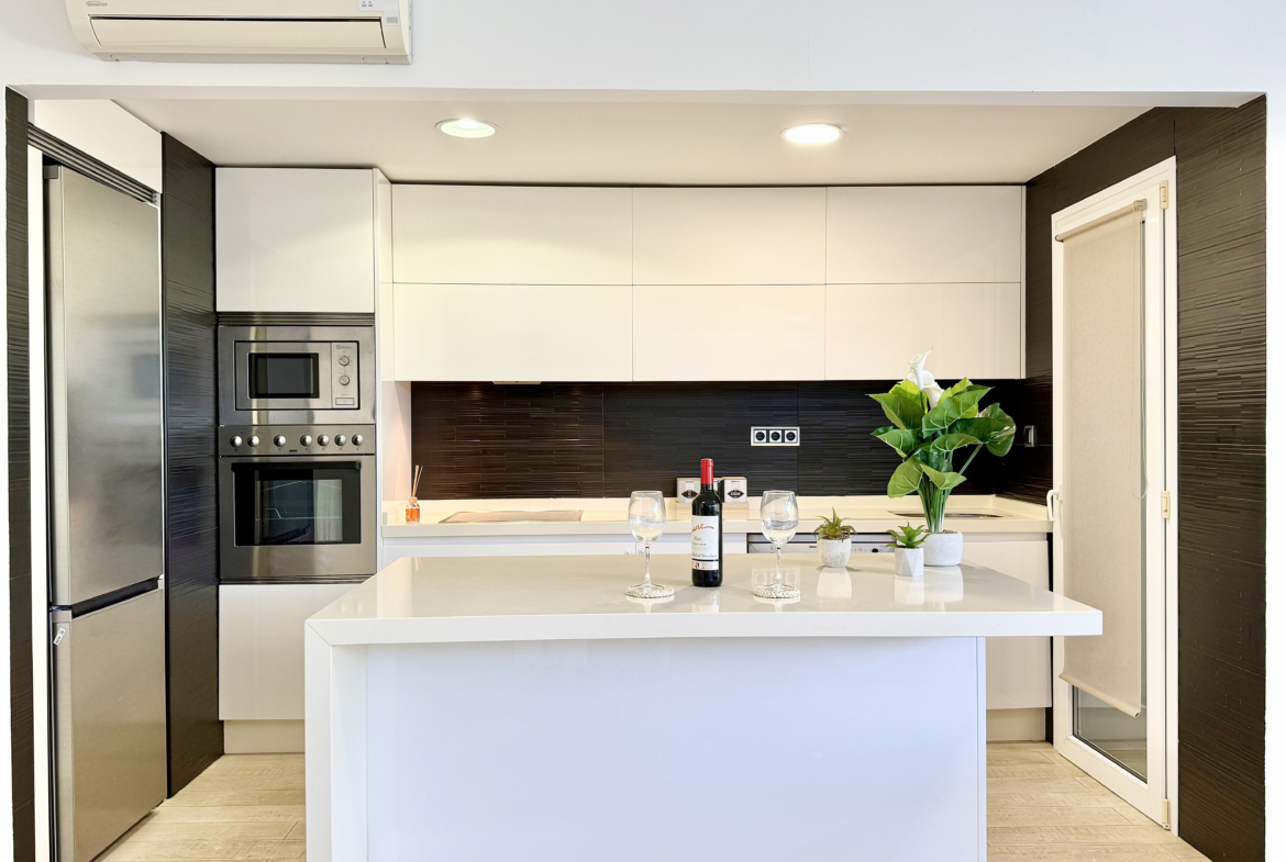 Open-plan kitchen with island in exclusive 4 bed villa for sale on Mar Menor Golf Resort – Levante Properties