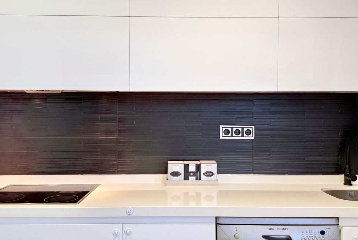 Open-plan kitchen with island in exclusive 4 bed villa for sale on Mar Menor Golf Resort – Levante Properties