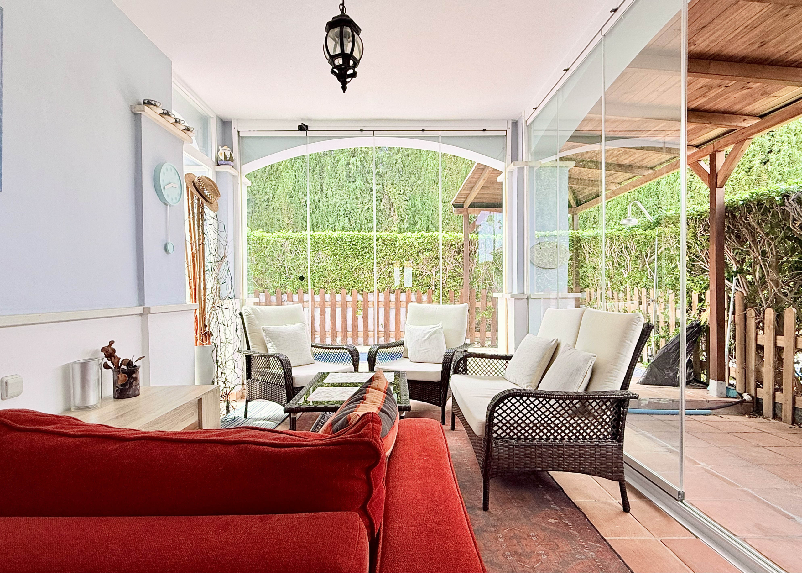 Garden patio with glass curtains at Ciervo villa in Mar Menor Golf Resort by Levante Properties