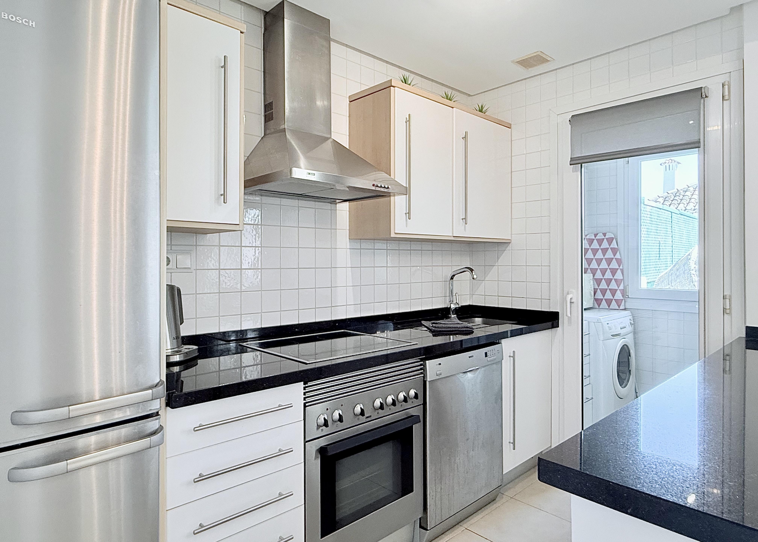 Open plan kitchen and dining area in Isla Grosa villa on Mar Menor Golf Resort by Levante Properties