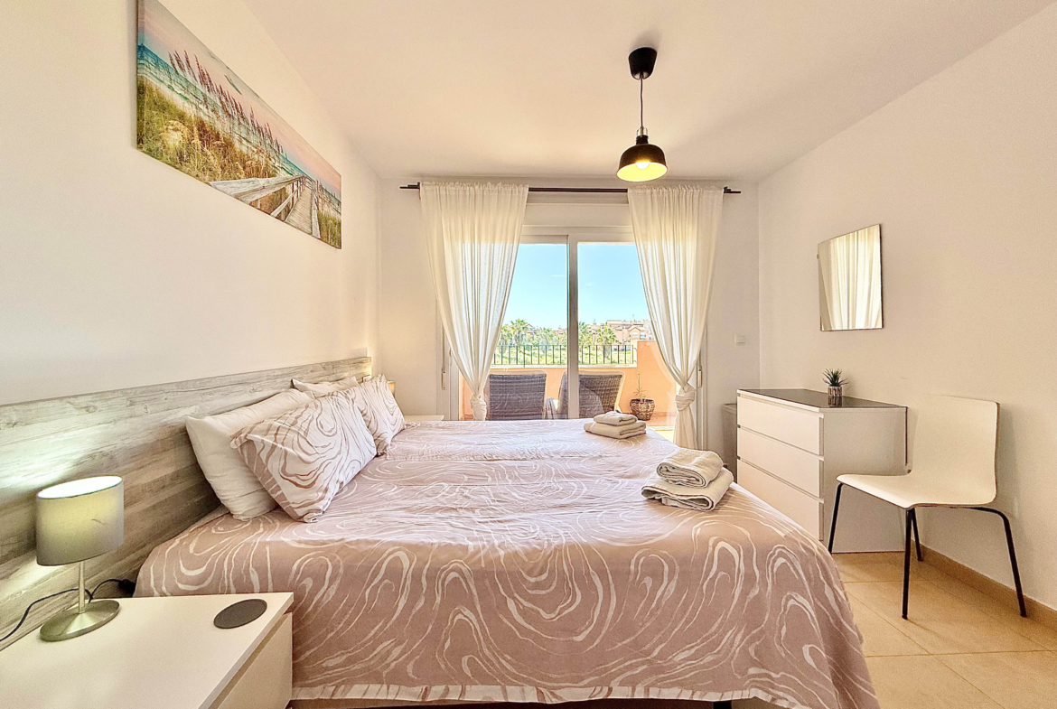 Master bedroom with terrace access in Mar Menor Golf Resort apartment for sale