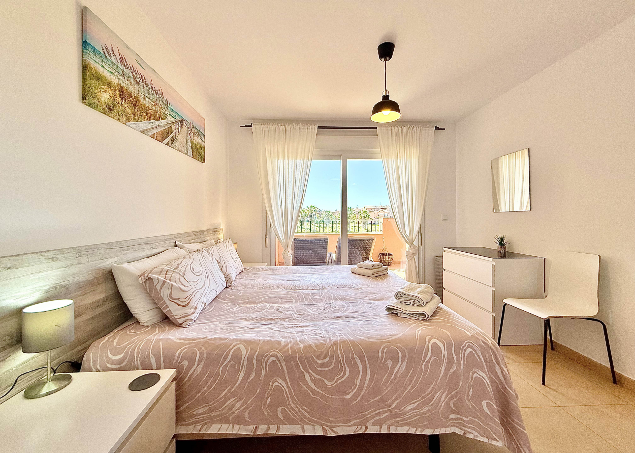 Master bedroom with terrace access in Mar Menor Golf Resort apartment for sale