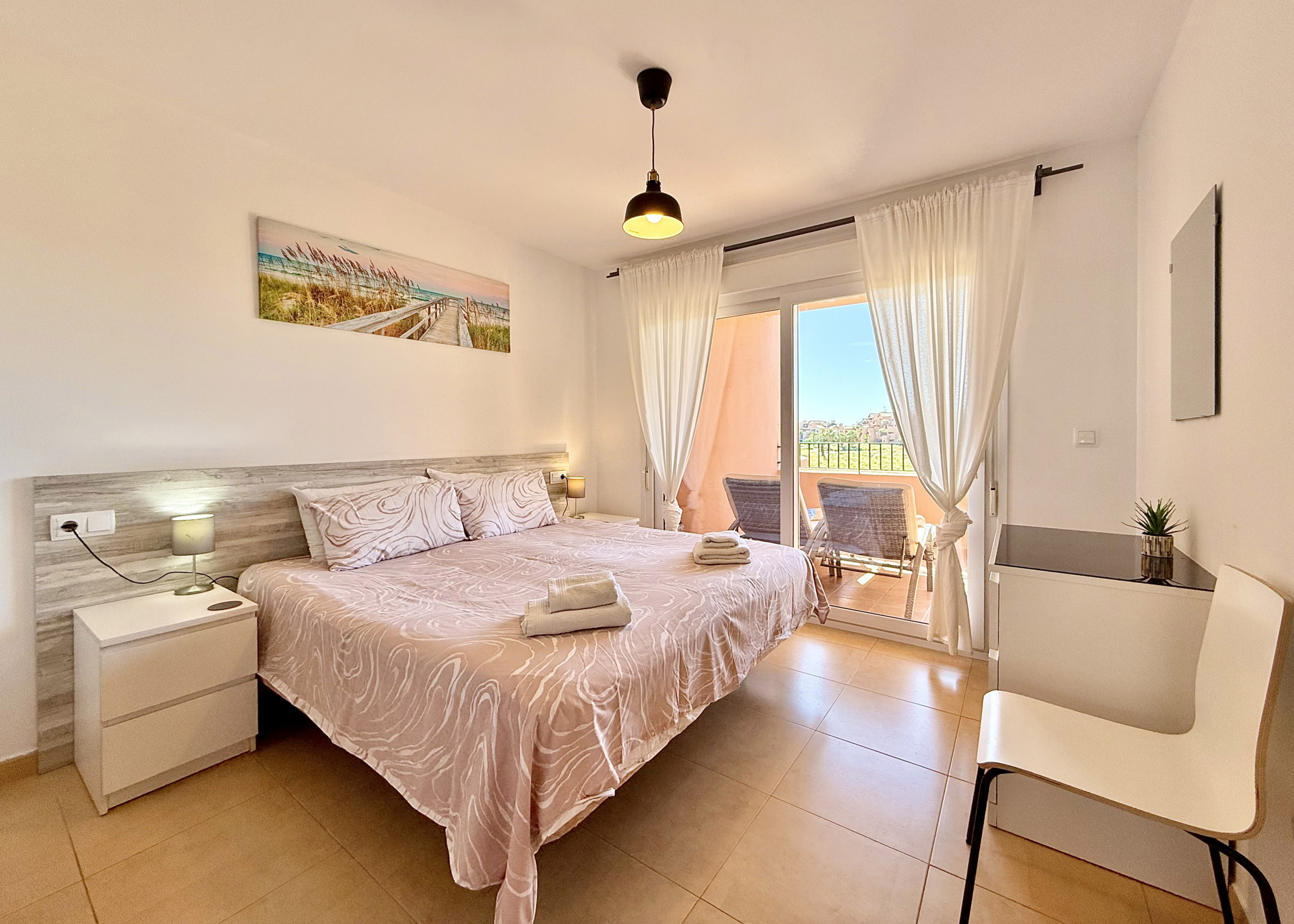 Master bedroom with terrace access in Mar Menor Golf Resort apartment for sale