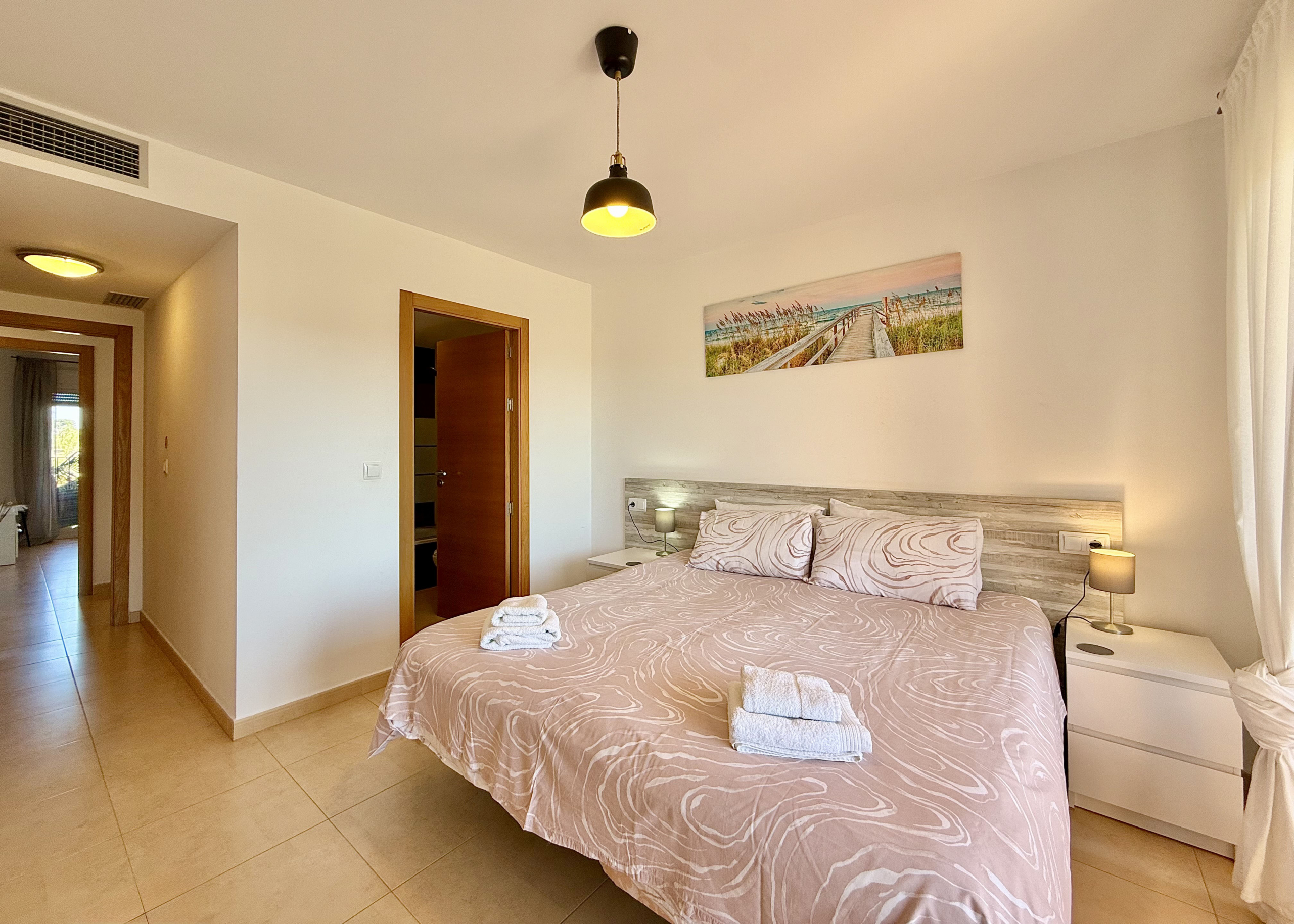 Master bedroom with terrace access in Mar Menor Golf Resort apartment for sale