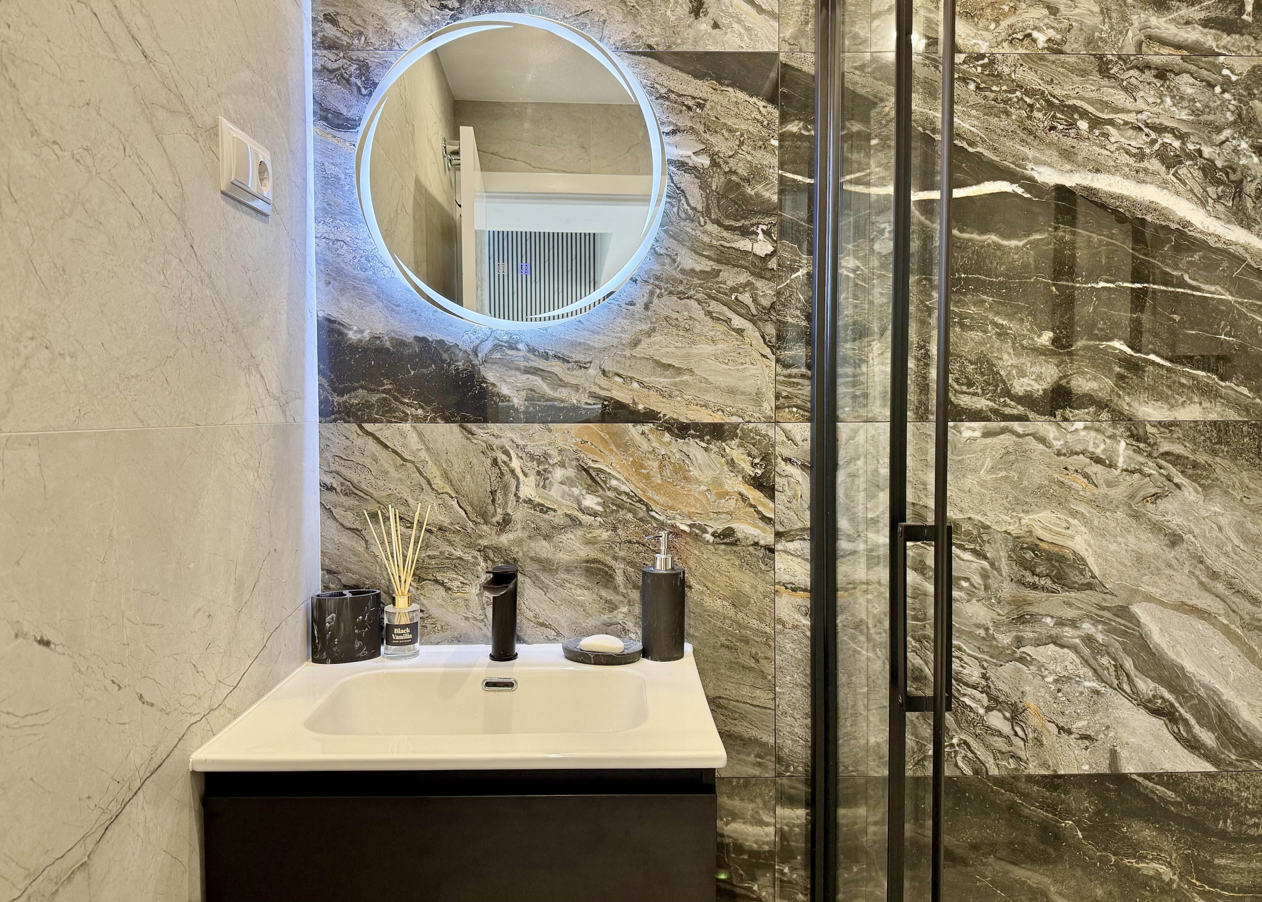 Luxury guest bathroom with walk-in shower in Calblanque Villa at Mar Menor Golf Resort by Levante Properties.
