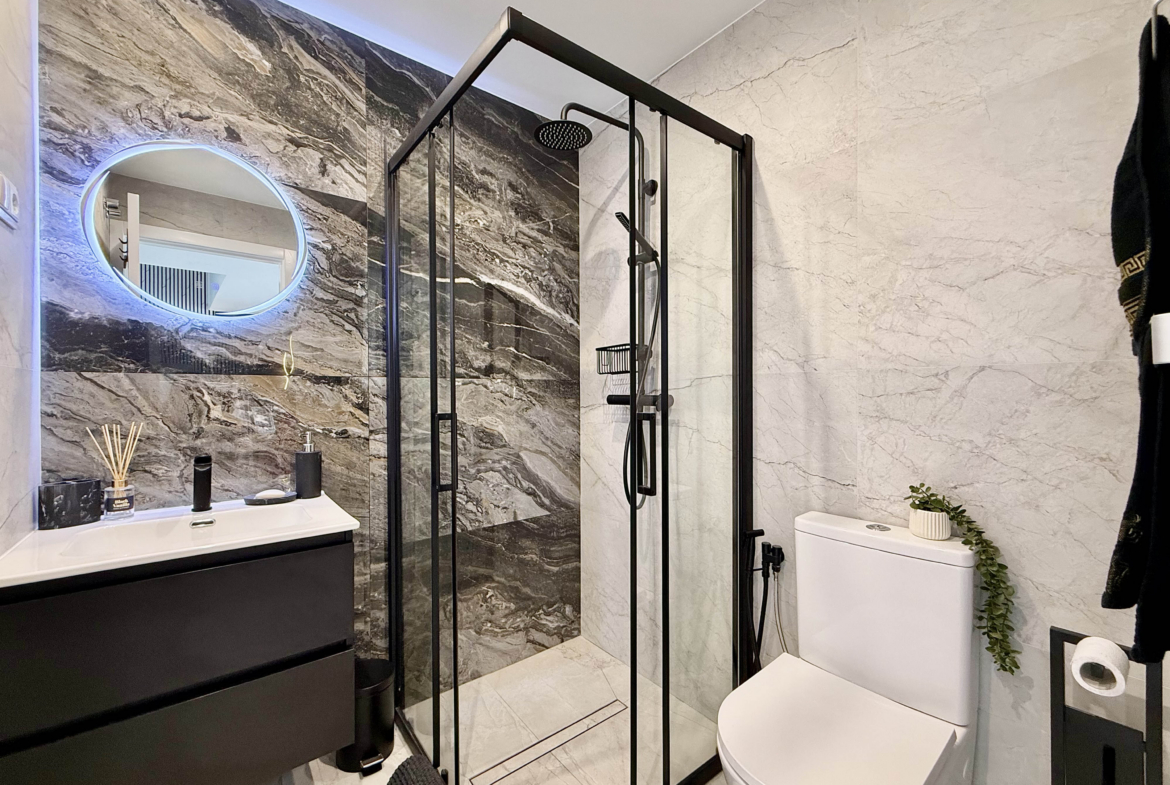 Luxury guest bathroom with walk-in shower in Calblanque Villa at Mar Menor Golf Resort by Levante Properties.