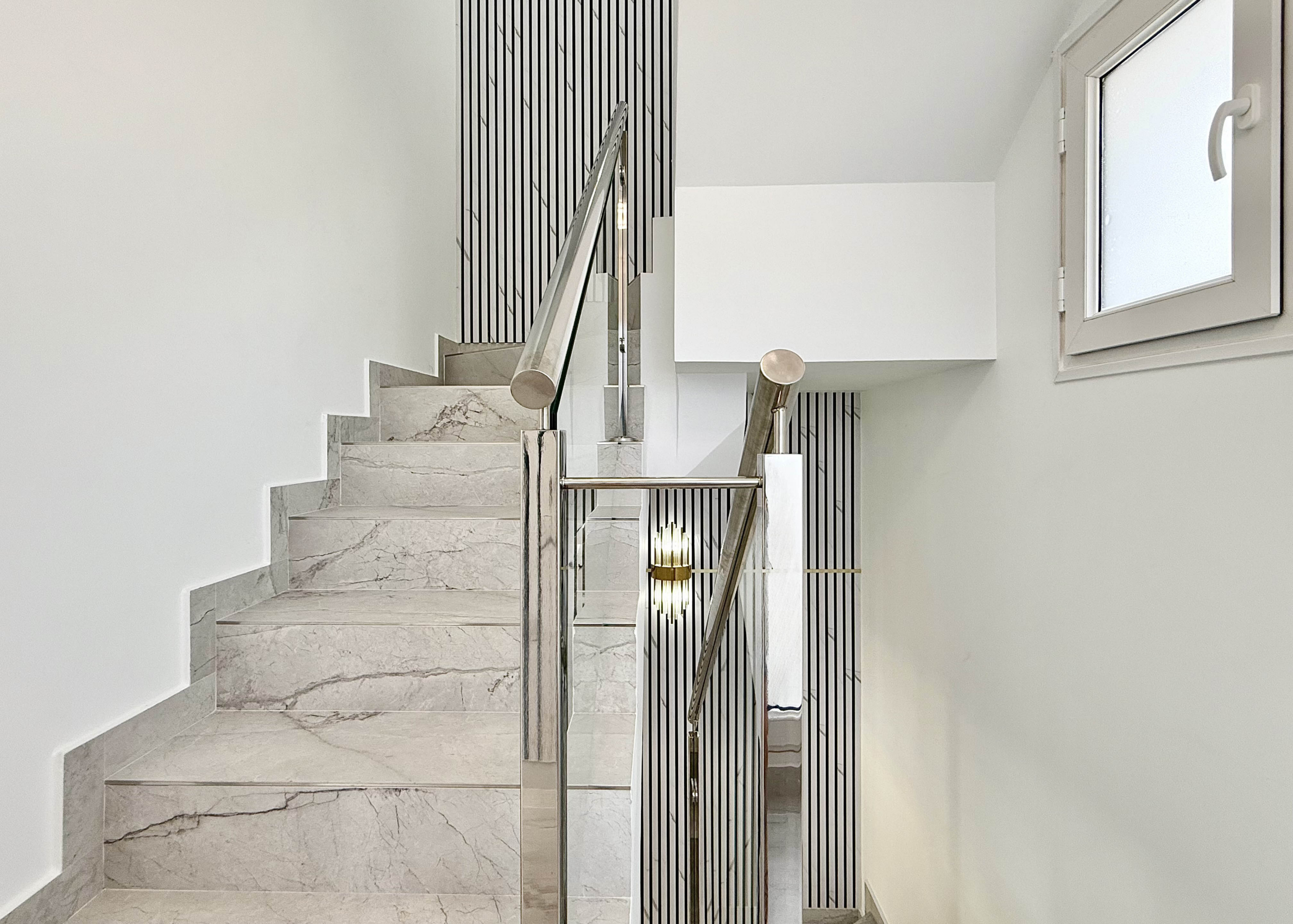 Designer staircase with glass balustrade in Calblanque Villa at Mar Menor Golf Resort