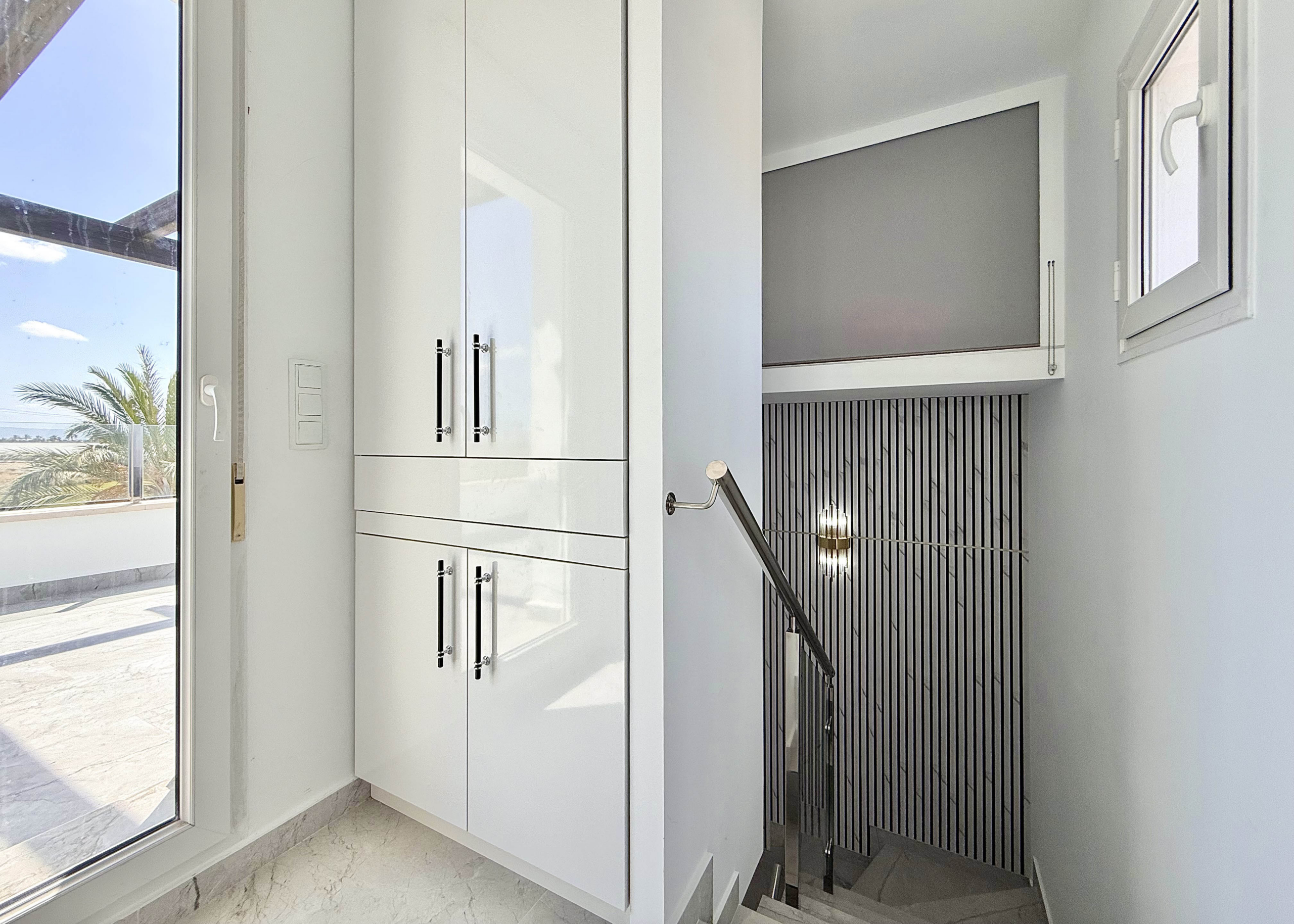 Designer staircase with glass balustrade in Calblanque Villa at Mar Menor Golf Resort