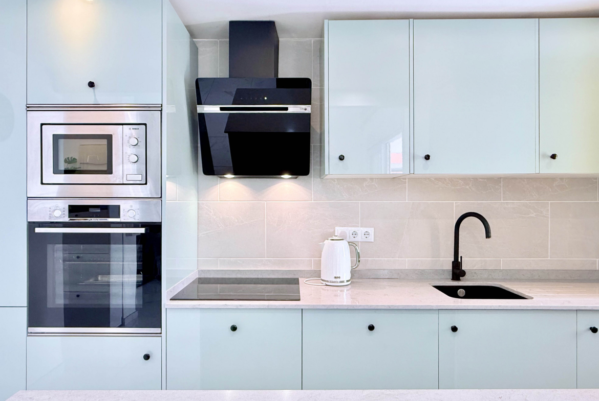 Contemporary kitchen with integrated appliances in Isla Grosa Villa on Mar Menor Golf Resort by Levante Properties