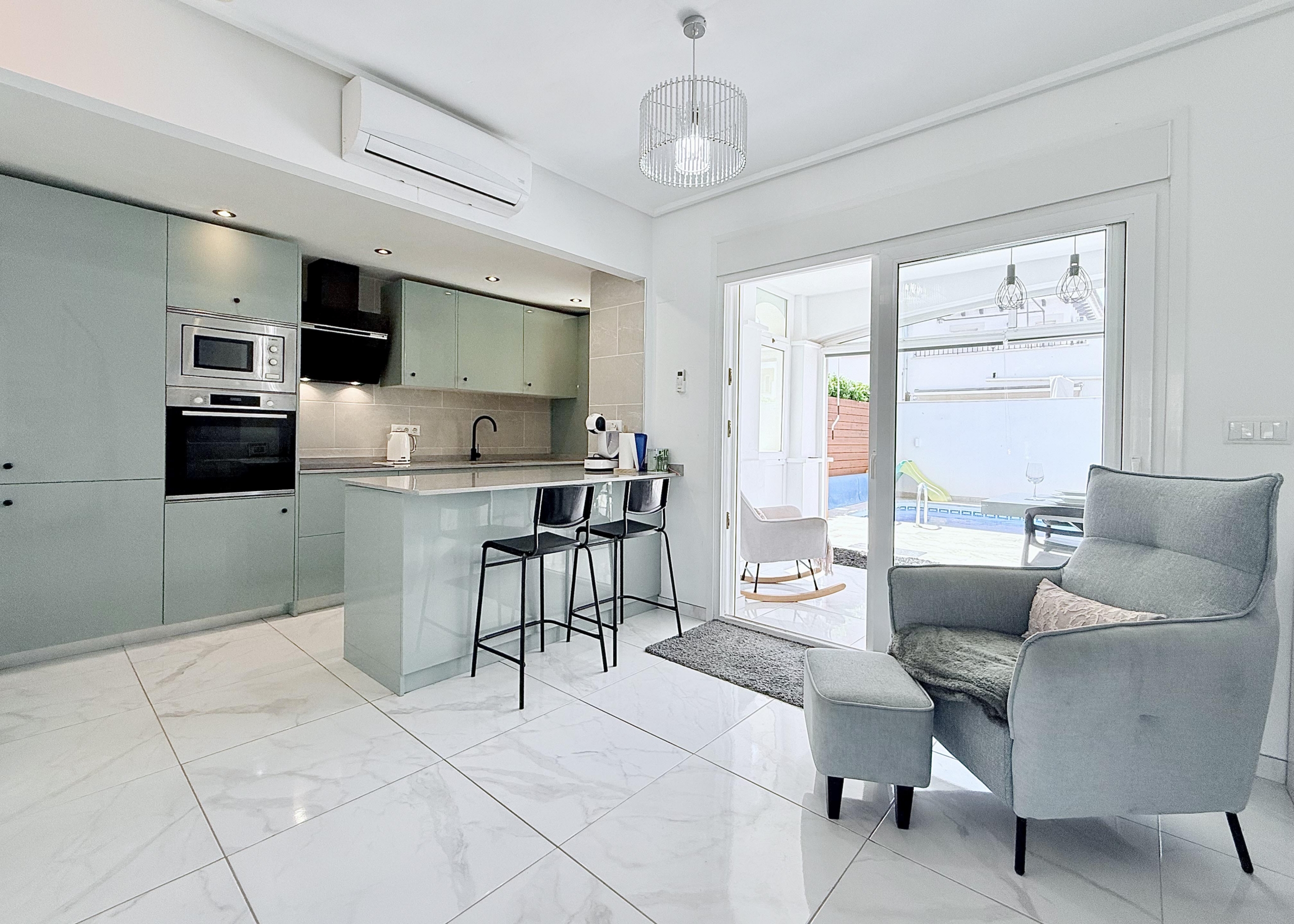 Contemporary kitchen with integrated appliances in Isla Grosa Villa on Mar Menor Golf Resort by Levante Properties