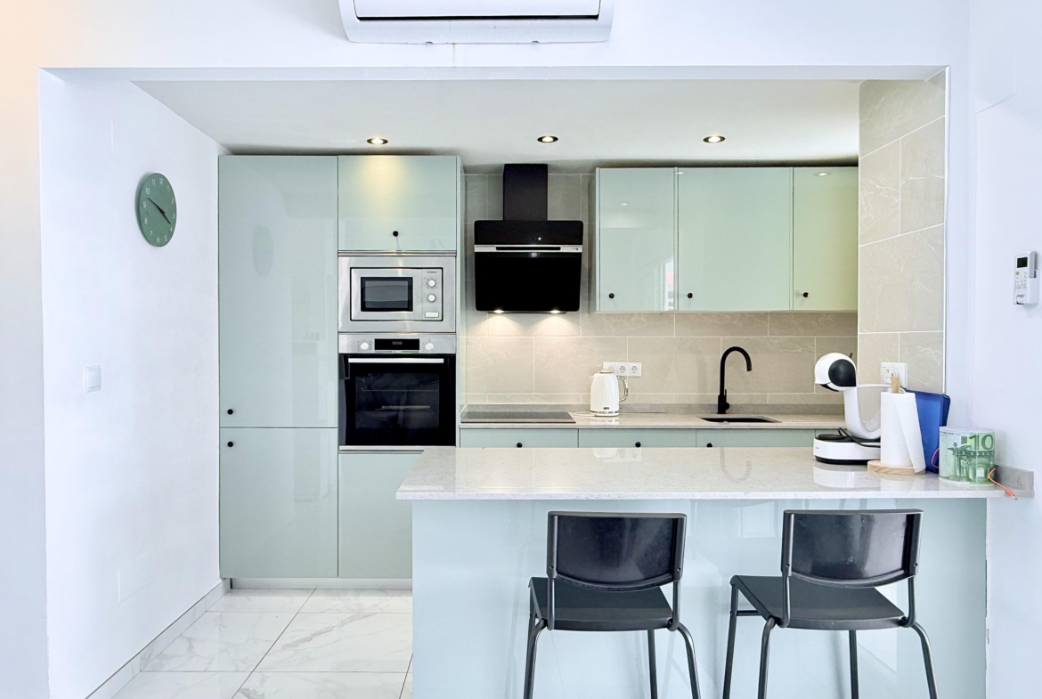 Contemporary kitchen with integrated appliances in Isla Grosa Villa on Mar Menor Golf Resort by Levante Properties