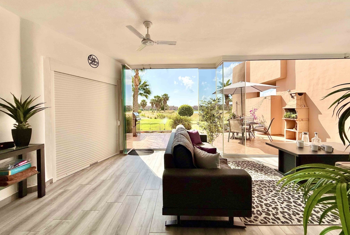 Glass curtain enclosed terrace creating a second lounge at Mar Menor Golf Resort | Levante Properties