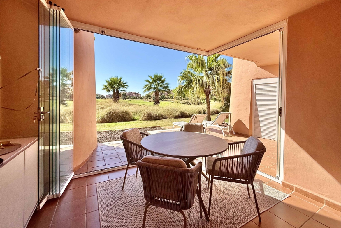 Enclosed terrace with glass curtains overlooking the golf course and lake at Mar Menor Golf Resort, exclusively marketed by Levante Properties.