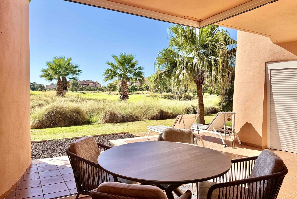 Enclosed terrace with glass curtains overlooking the golf course and lake at Mar Menor Golf Resort, exclusively marketed by Levante Properties.