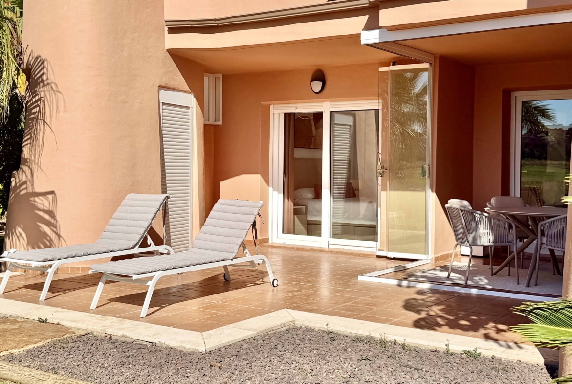 Private west-facing terrace with sun loungers at an upgraded one-bedroom apartment on Mar Menor Golf Resort, exclusively marketed by Levante Properties.