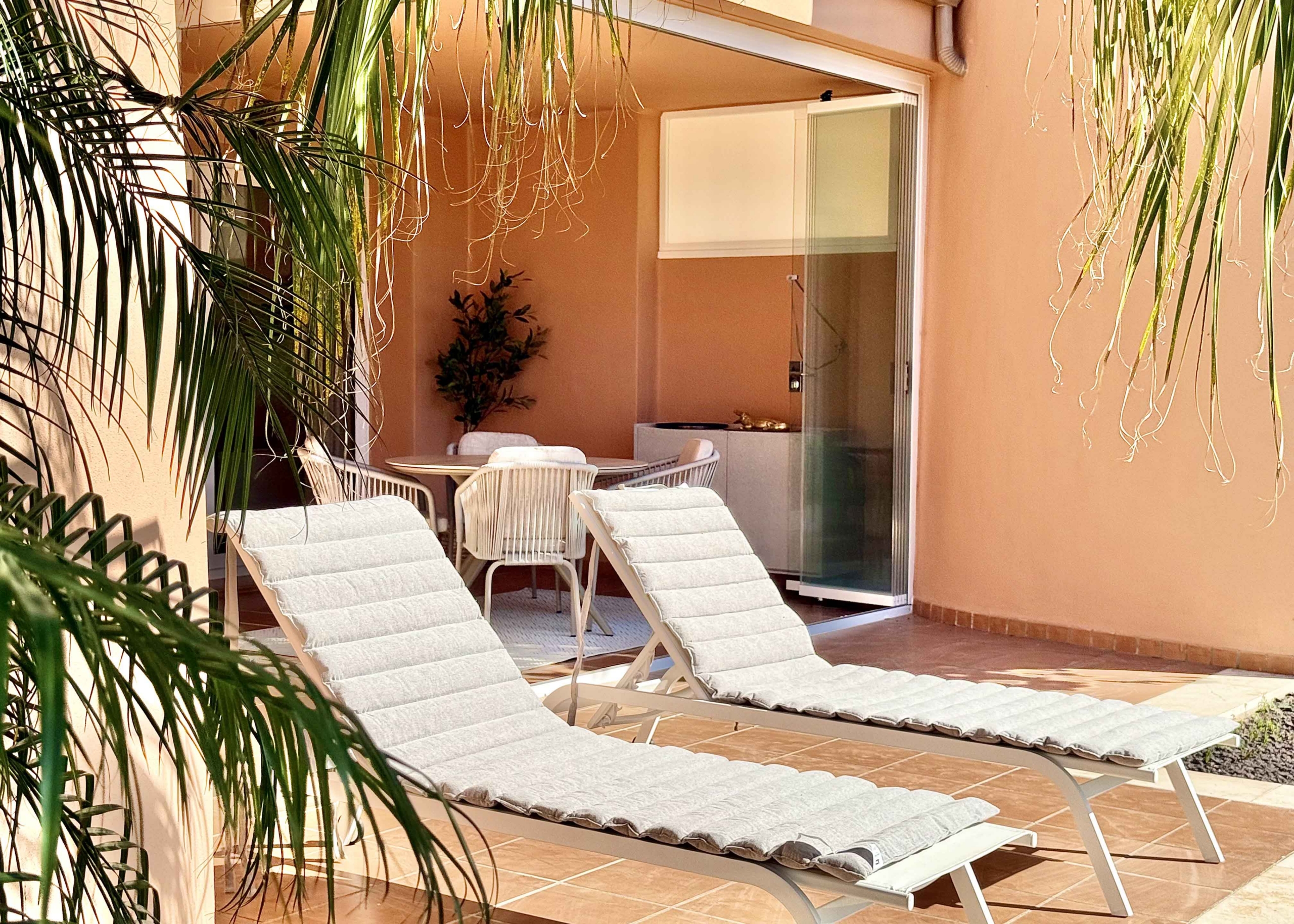 Private west-facing terrace with sun loungers at an upgraded one-bedroom apartment on Mar Menor Golf Resort, exclusively marketed by Levante Properties.
