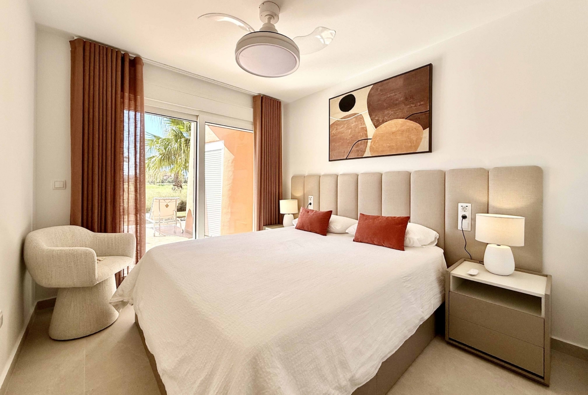 Modern master bedroom in an upgraded one-bedroom apartment for sale on Mar Menor Golf Resort with direct terrace access, exclusively by Levante Properties.