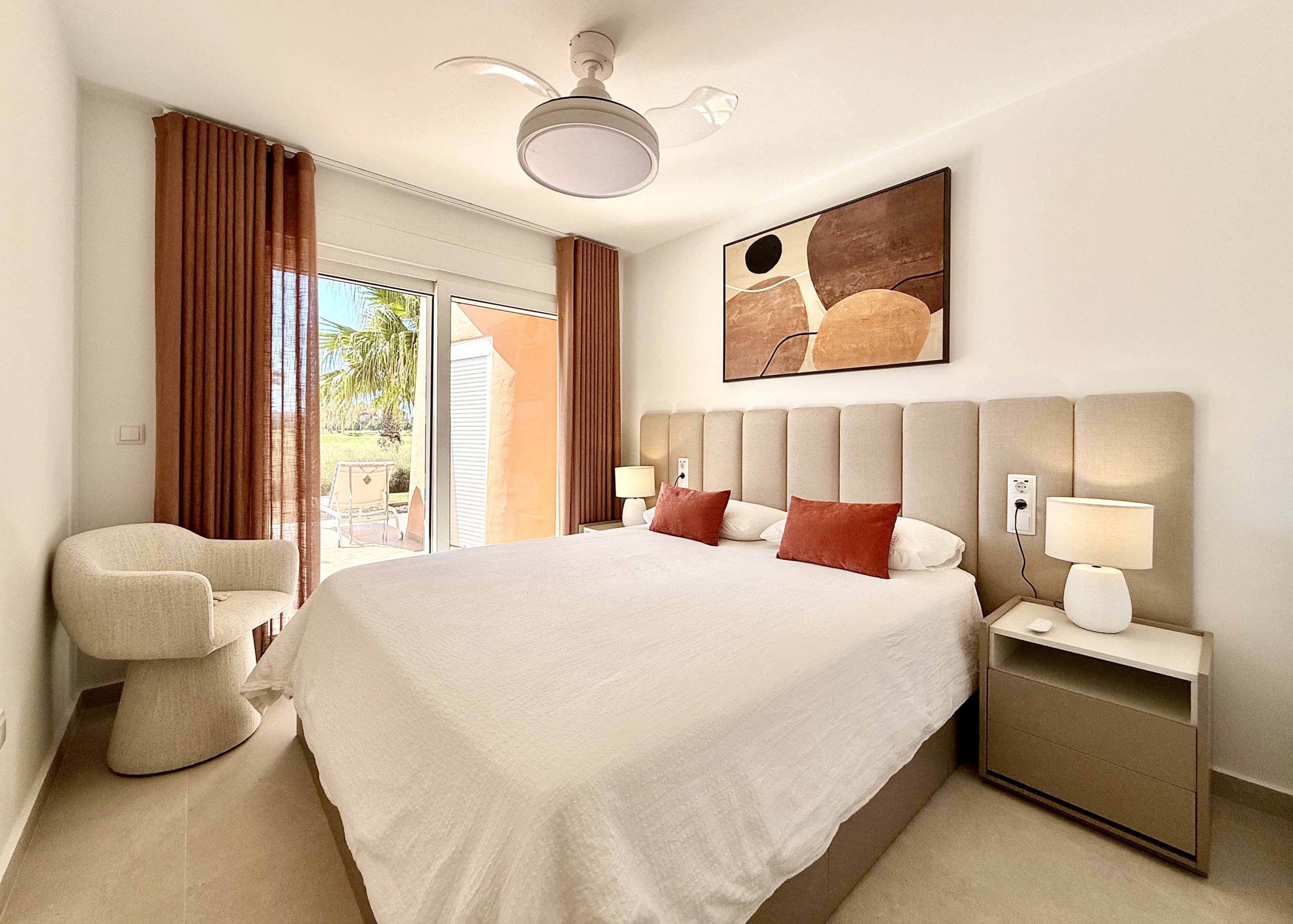 Modern master bedroom in an upgraded one-bedroom apartment for sale on Mar Menor Golf Resort with direct terrace access, exclusively by Levante Properties.