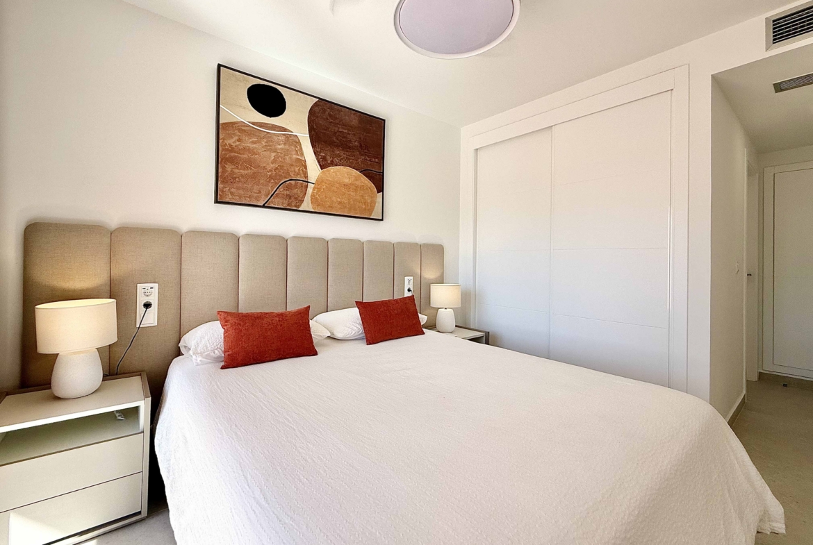 Modern master bedroom in an upgraded one-bedroom apartment for sale on Mar Menor Golf Resort with direct terrace access, exclusively by Levante Properties.