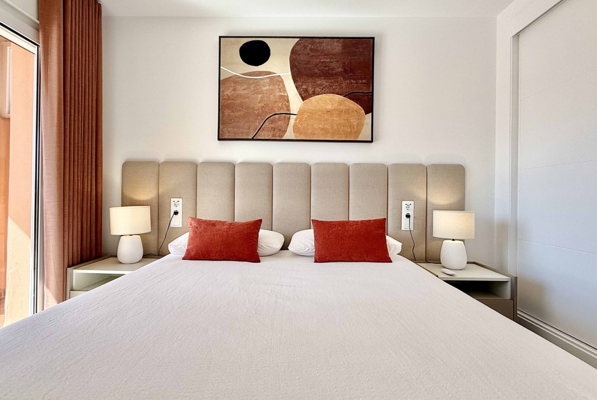 Modern master bedroom in an upgraded one-bedroom apartment for sale on Mar Menor Golf Resort with direct terrace access, exclusively by Levante Properties.