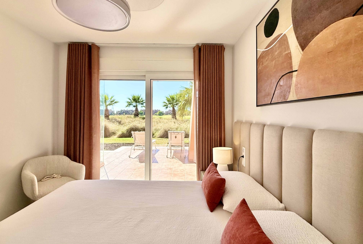 Modern master bedroom in an upgraded one-bedroom apartment for sale on Mar Menor Golf Resort with direct terrace access, exclusively by Levante Properties.