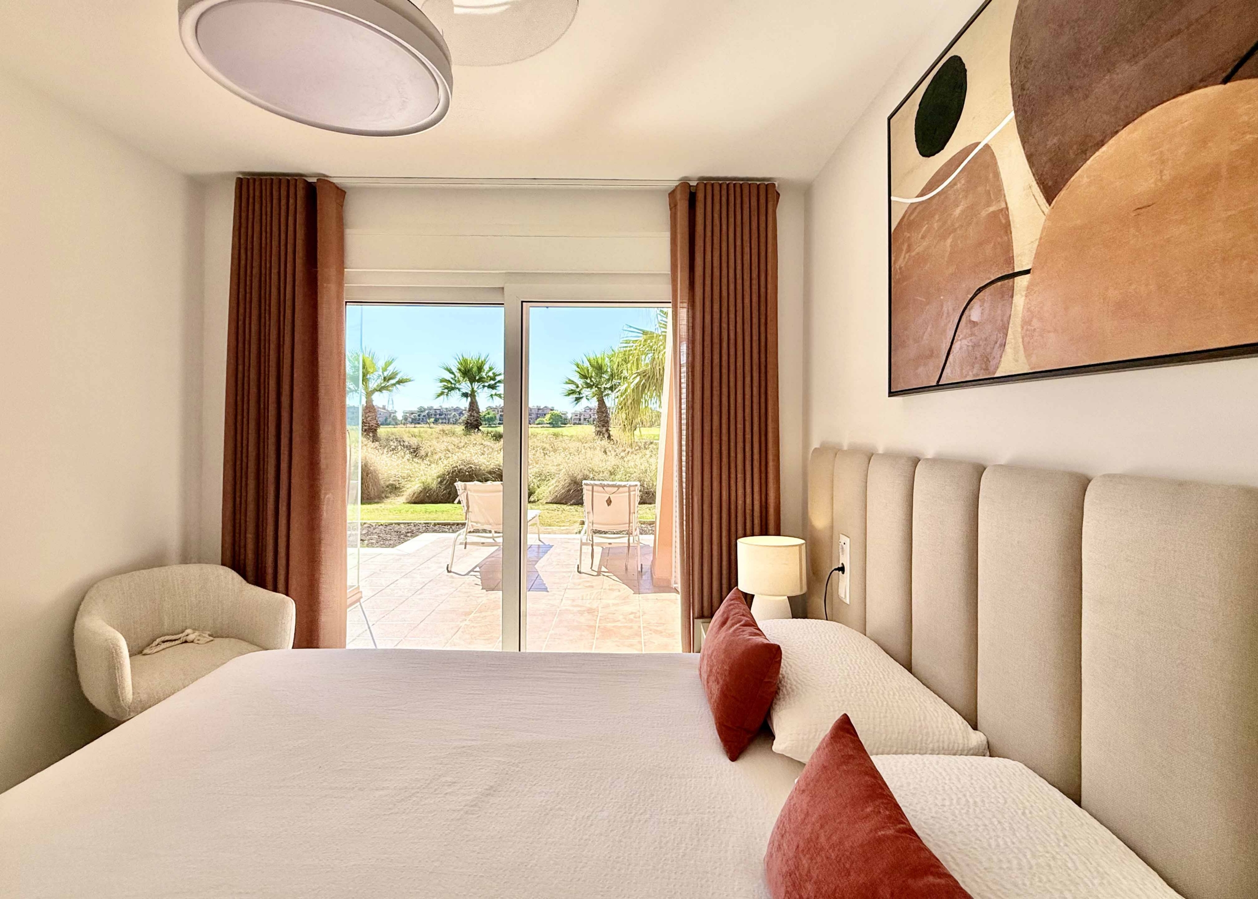Modern master bedroom in an upgraded one-bedroom apartment for sale on Mar Menor Golf Resort with direct terrace access, exclusively by Levante Properties.