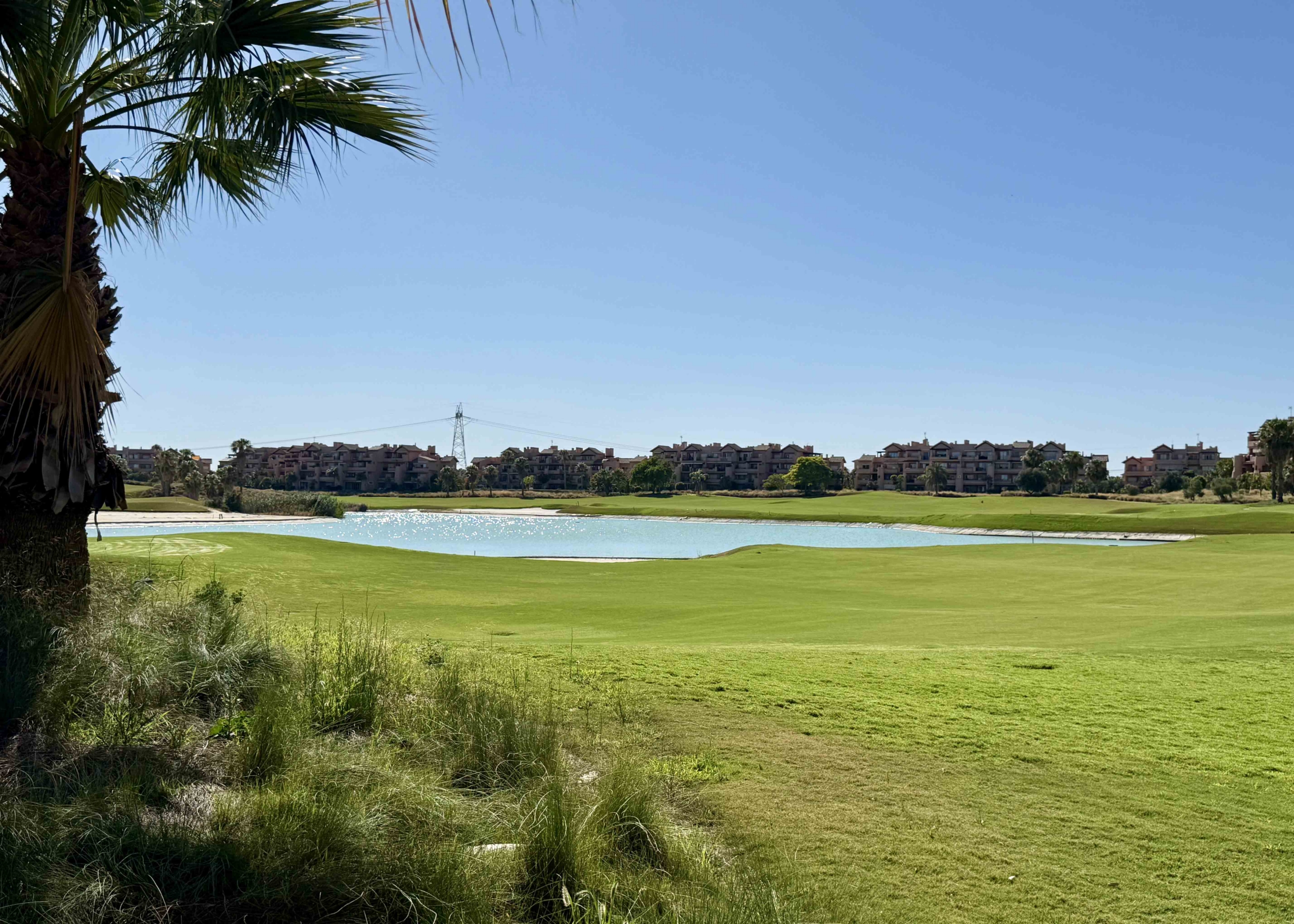 Panoramic golf course and lake views from an upgraded one-bedroom apartment on Mar Menor Golf Resort, exclusively marketed by Levante Properties.