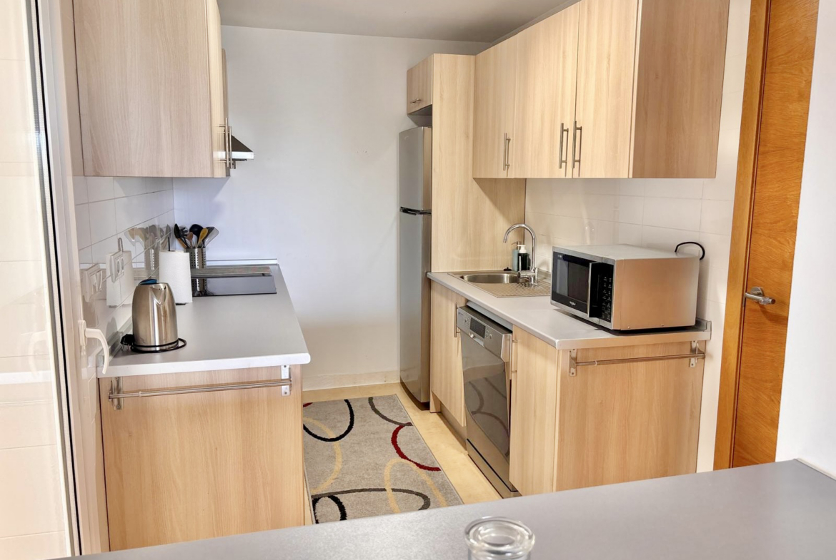 Fully equipped kitchen with light wood cabinetry in a Boulevard apartment on Mar Menor Golf Resort