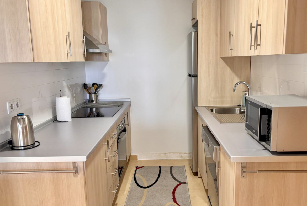 Fully equipped kitchen with light wood cabinetry in a Boulevard apartment on Mar Menor Golf Resort
