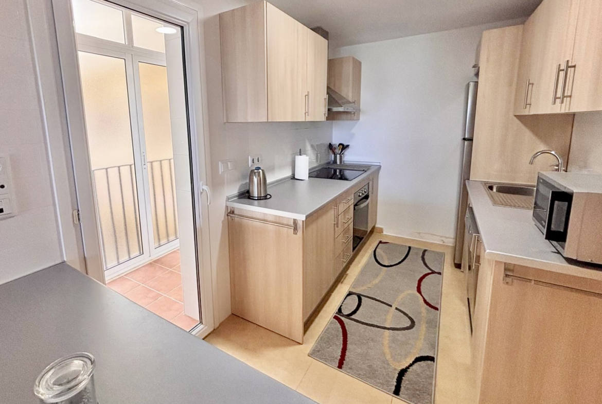 Fully equipped kitchen with light wood cabinetry in a Boulevard apartment on Mar Menor Golf Resort