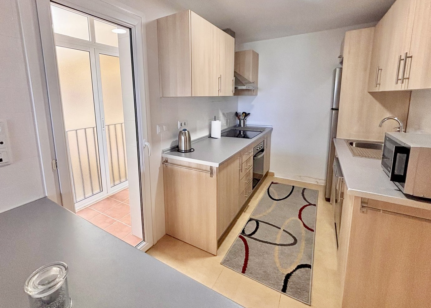 Fully equipped kitchen with light wood cabinetry in a Boulevard apartment on Mar Menor Golf Resort
